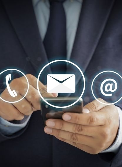Person using a phone with call, email and message icons